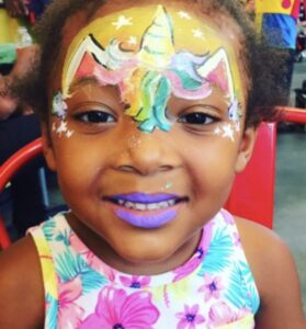 photo of rainbow unicorn face painting by Kiki's Faces and Balloons NYC